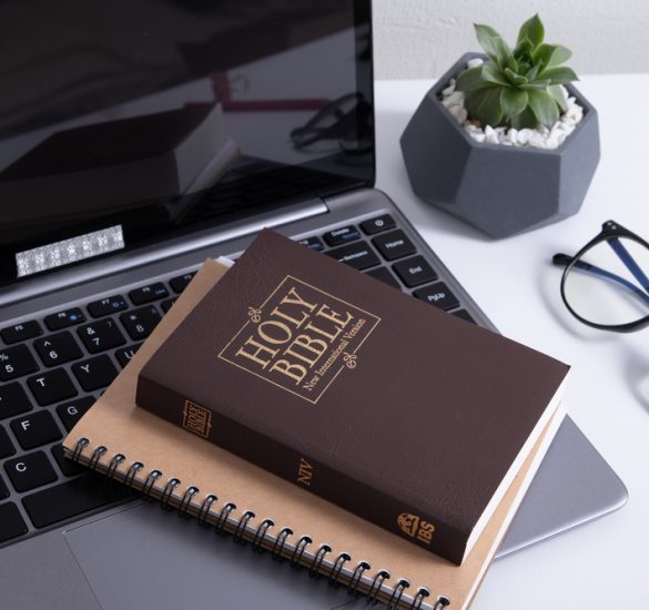 Bible and laptop on the work table with headphones. Bible Study Online concept